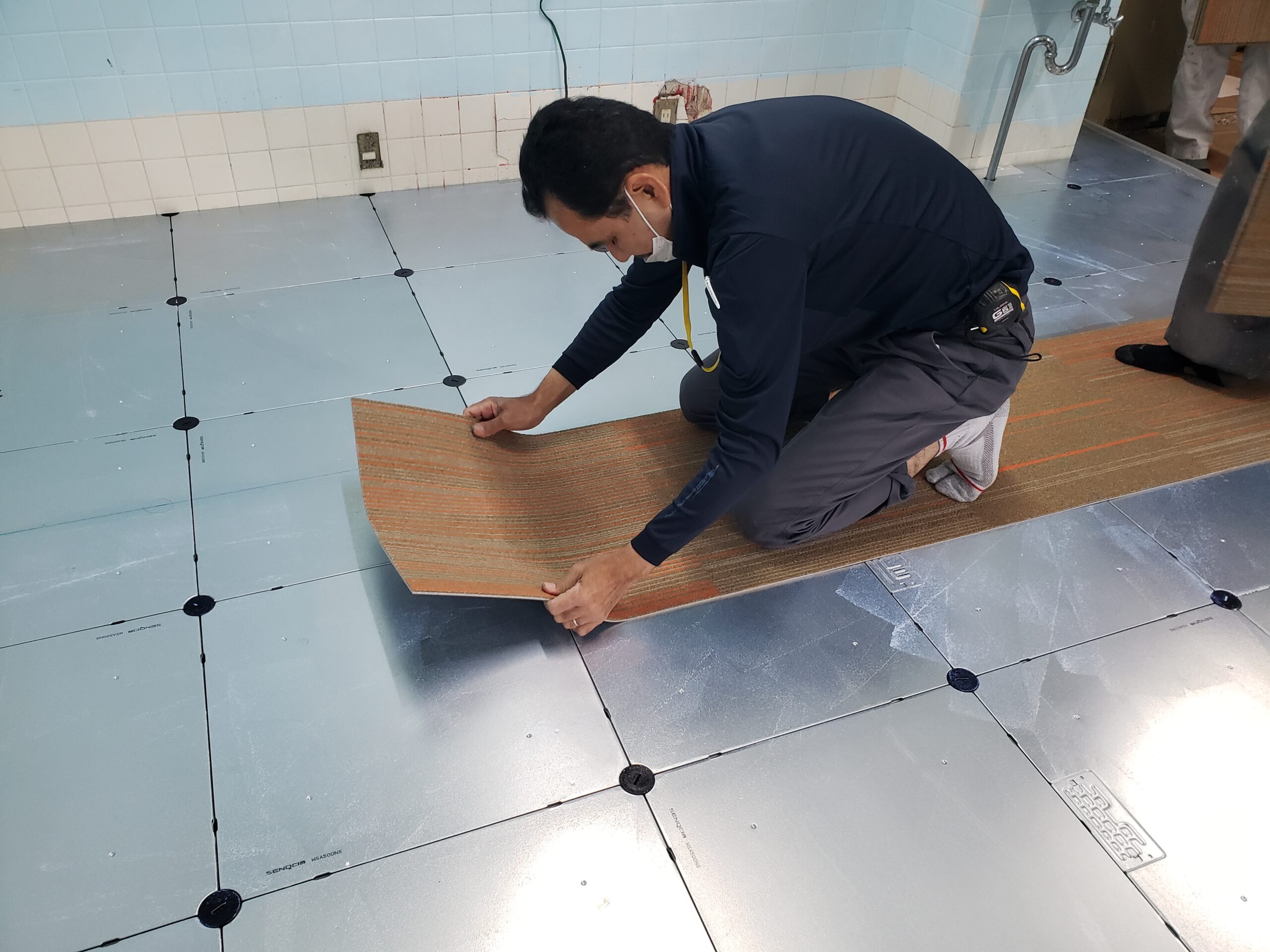 カーペットを基準になる列をずれないように慎重に貼っていきます。